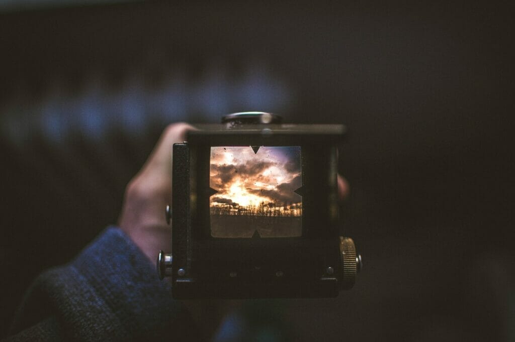 selective focus photography of person holding camera